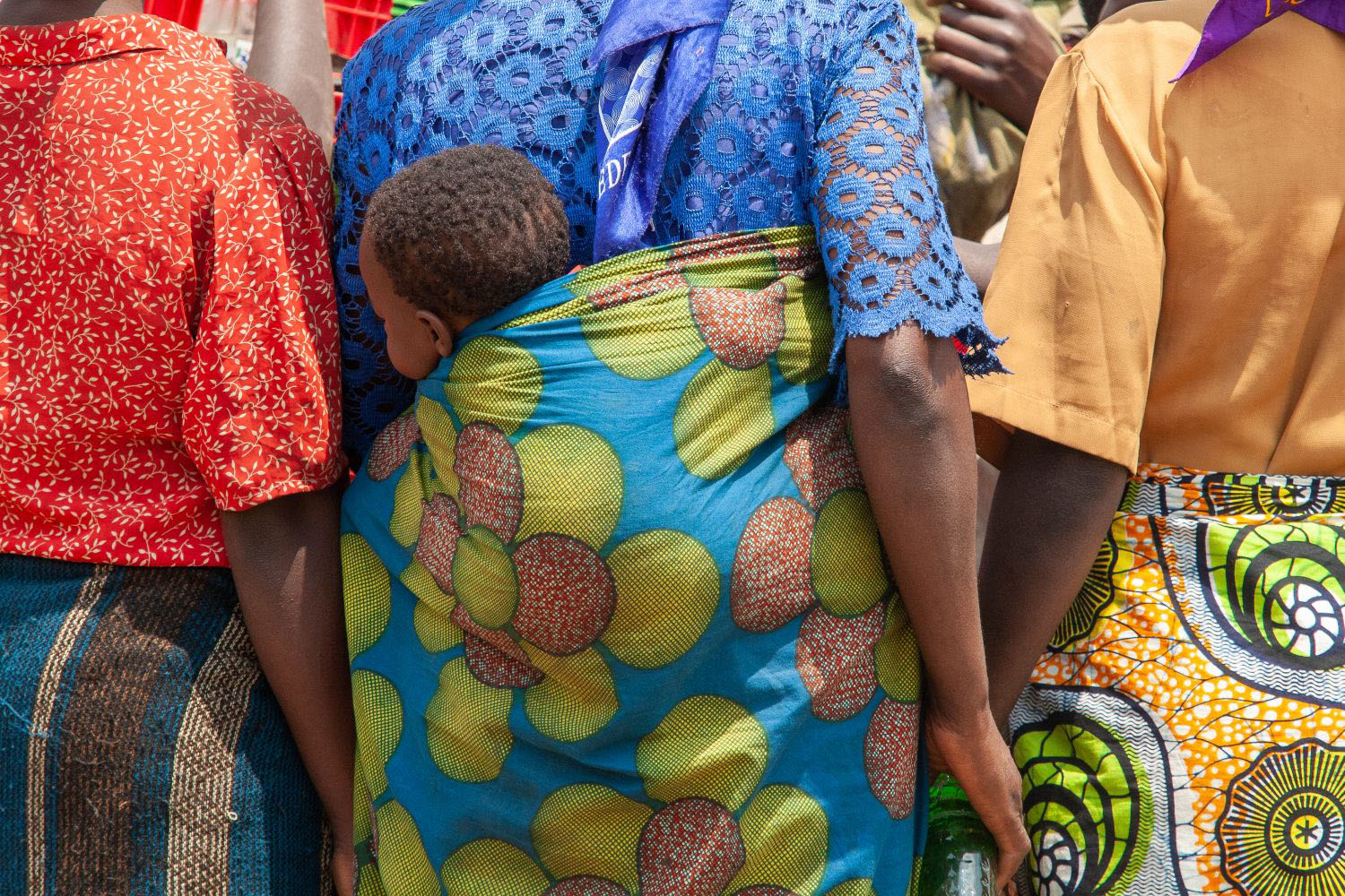 African mother carrying her child on her back 