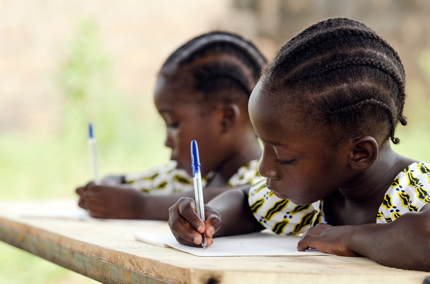 School girls writing at desk