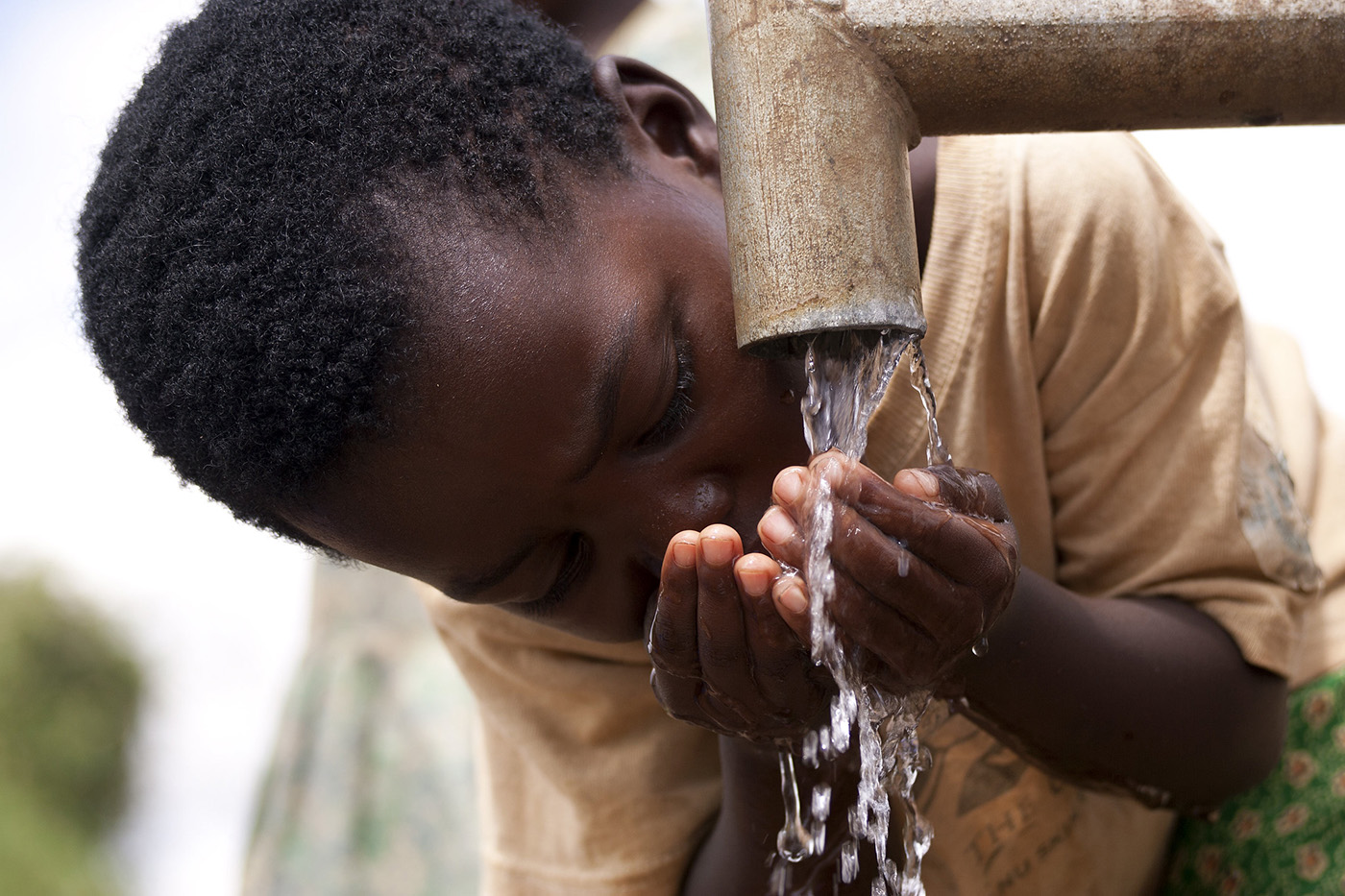  A child from Lonjezo Community Based Child Care Centre , in Dowa district, central region of Malawi accessing clean water from a borehole