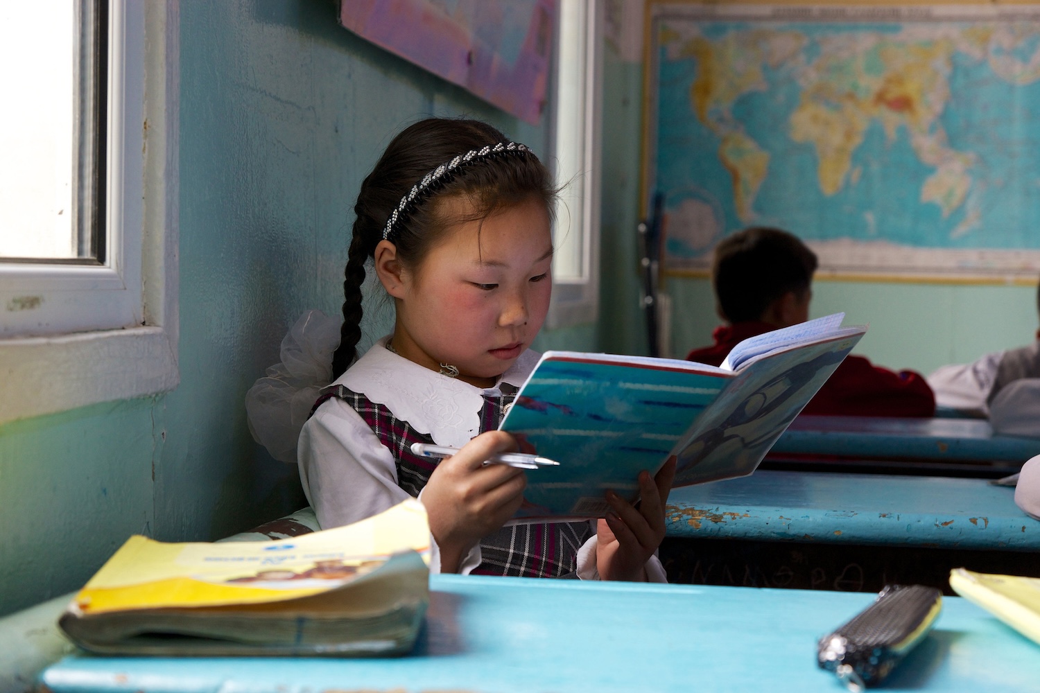 Young girl reading workbook 