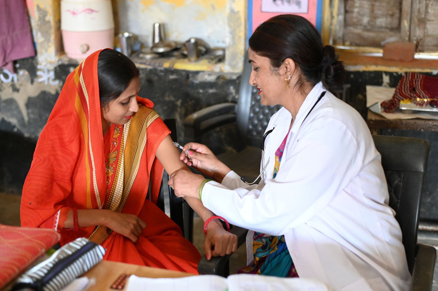 Female doctor administering an injection to a woman