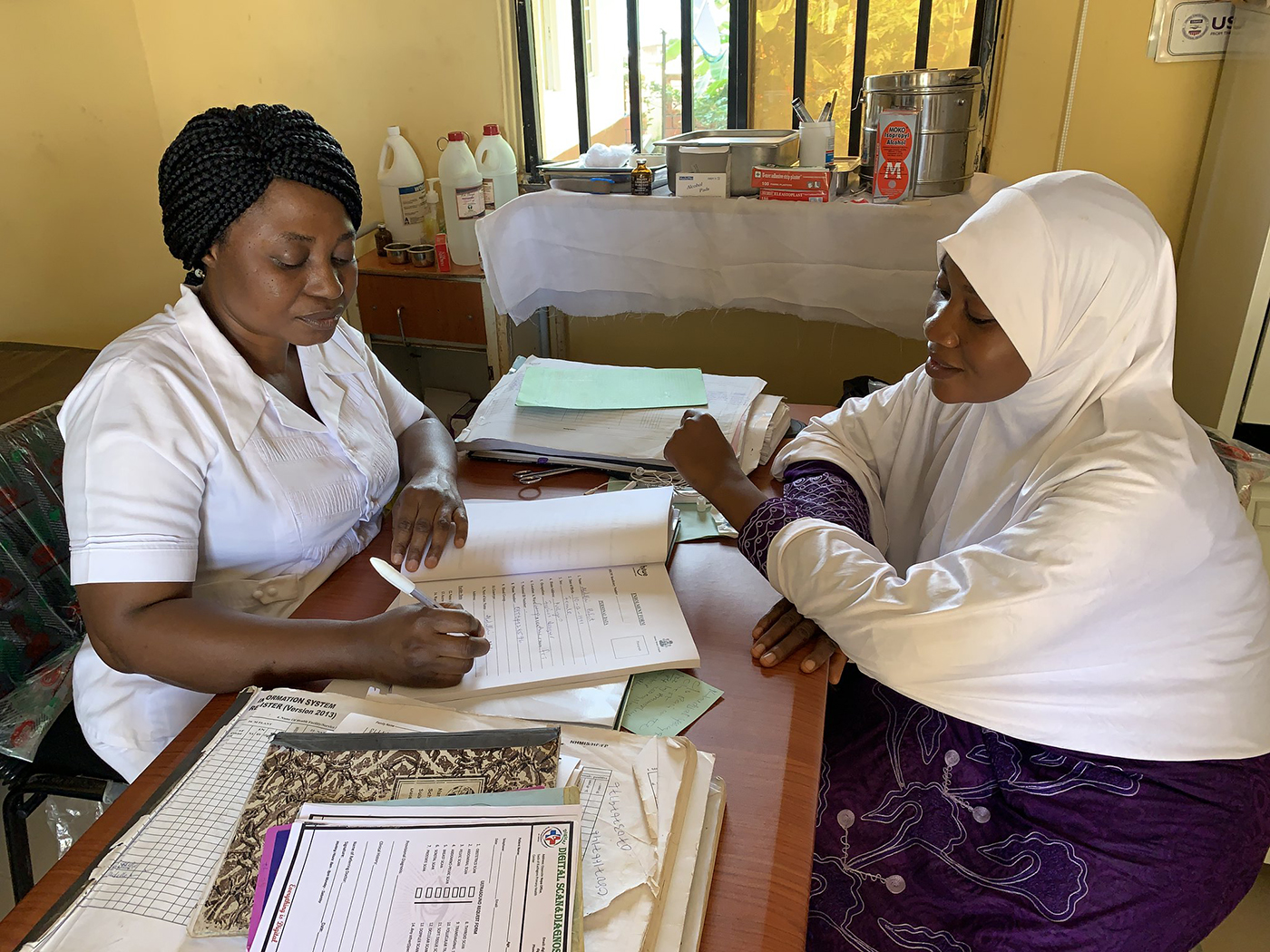 Nurse meets with a client at the Kuchingoro Primary Health Centre in Abuja, Nigeria