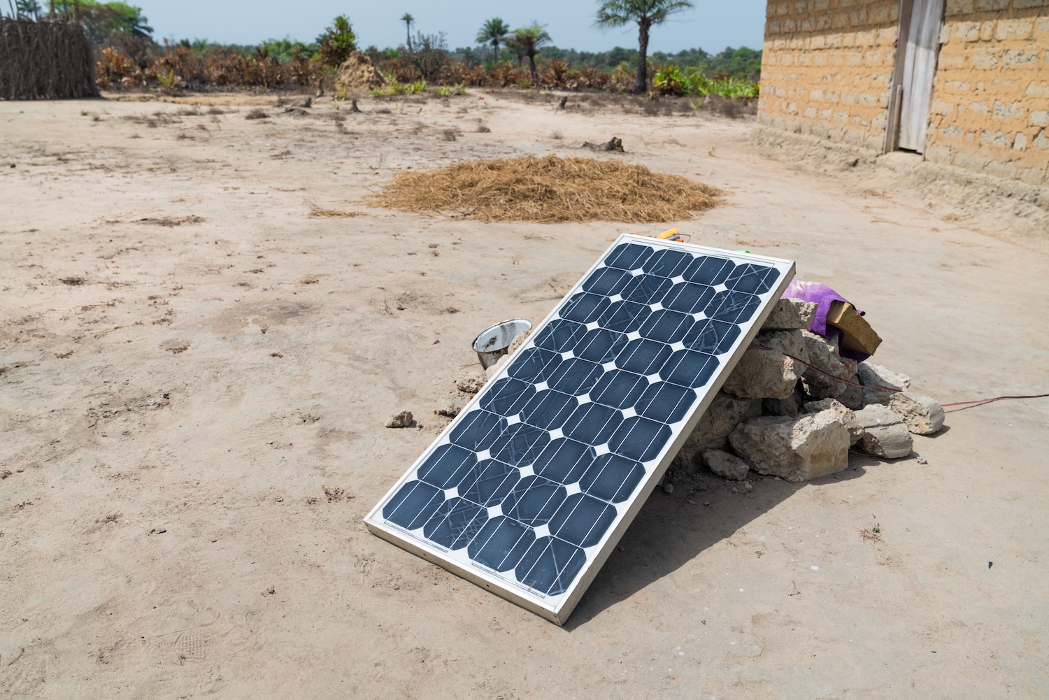 Downloaded Solar panel resting on rocks in West Africa 