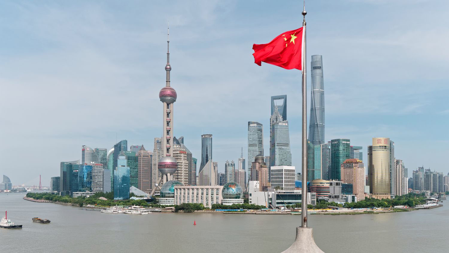 Skyline view of a city in China showing the China flag.