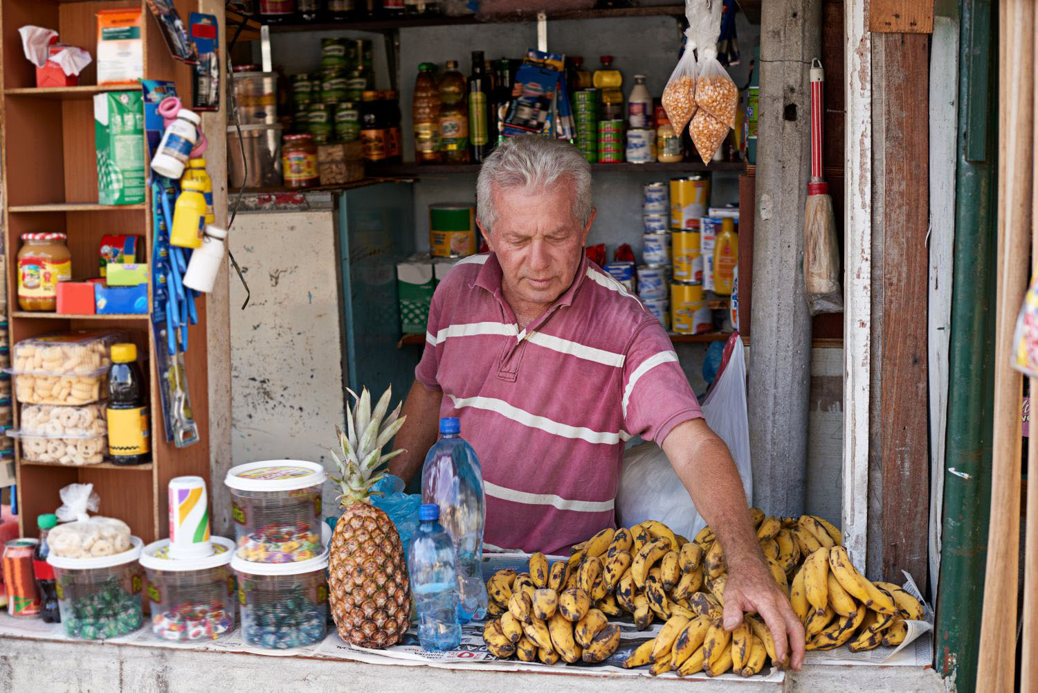 Shot of a street vendor selling a variety of food at his stall