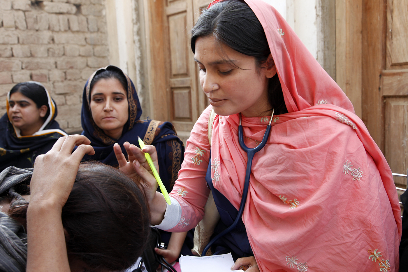  A female doctor with the International Medical Corps examines a woman patient at a mobile health clinic in Pakistan