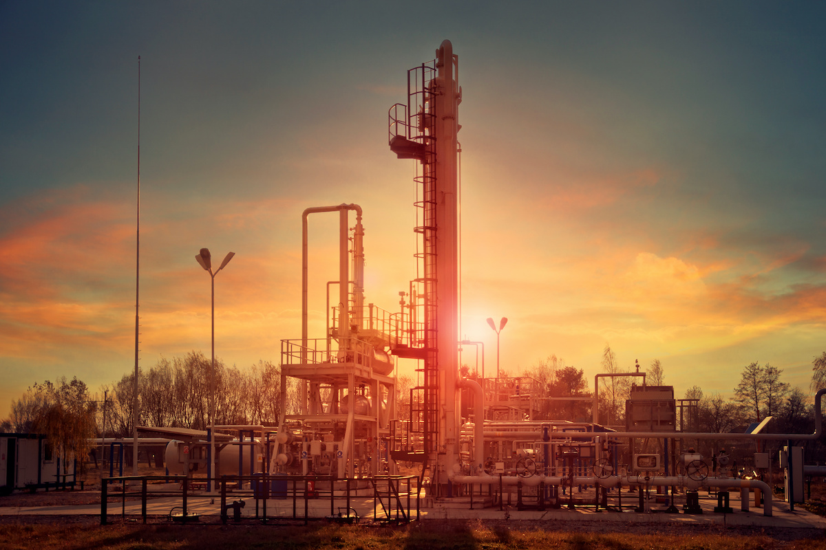 Sunset at a natural gas plant. Adobe Stock