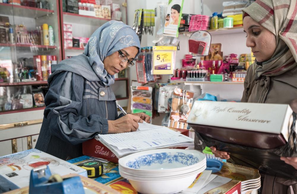 Photo of a Syrian woman running a small shop in Jordan