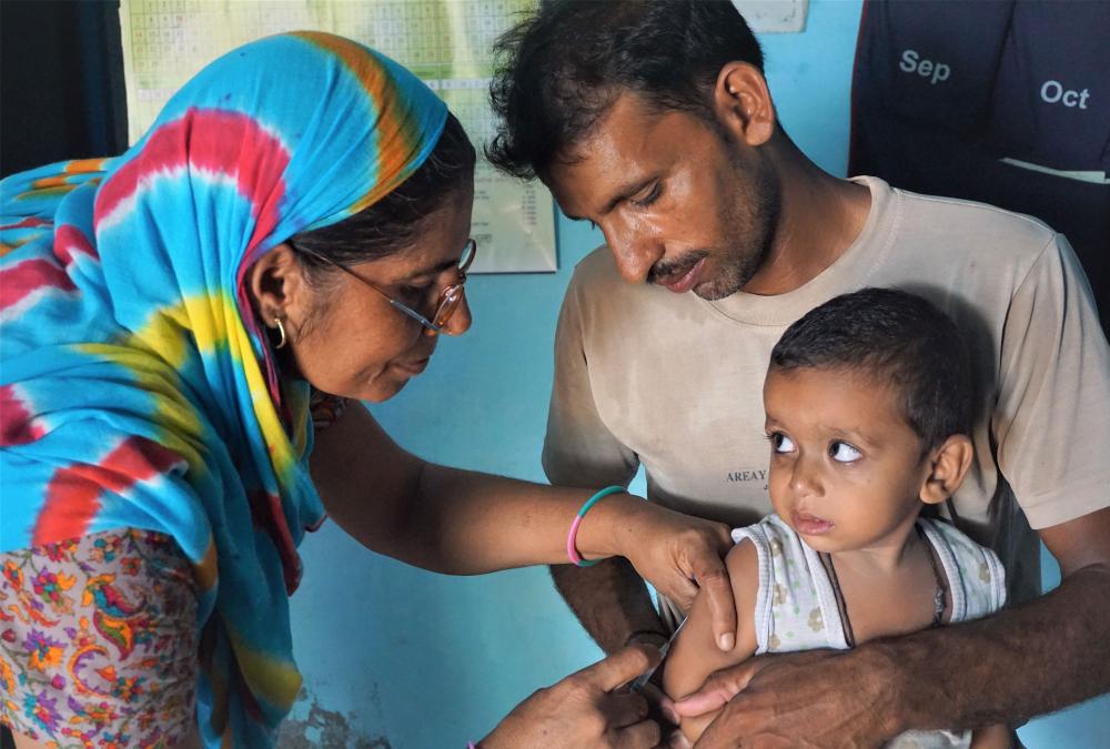 A nurse immunizes a child in India. Photo by Shobhini Mukerji for J-PAL