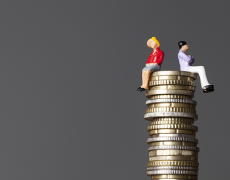 Image of a man and woman sitting on top of a pile of coins