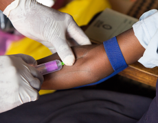 An image of a child in Uganda having blood drawn